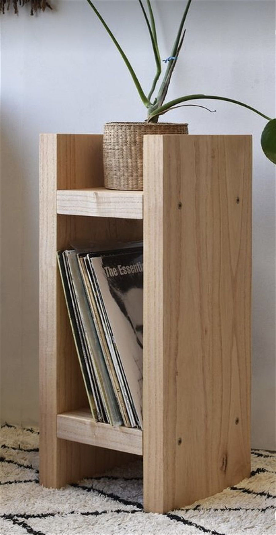 Narrow timber rack holding books and magazines.